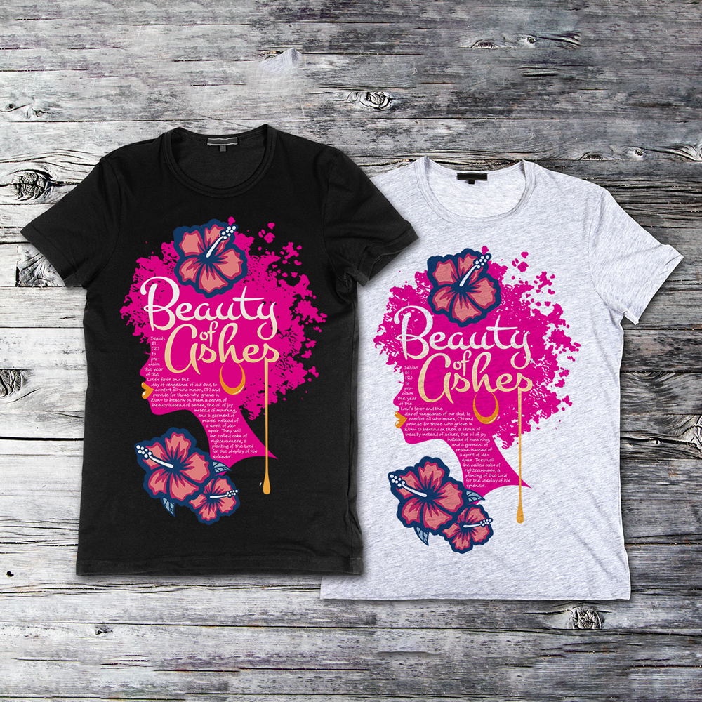Mockup of black and gray t-shirts showcasing the Beauty of Ashes design with pink floral afro silhouette and scripture text